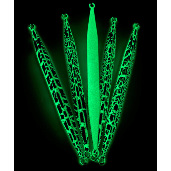 Check it out, folks! We’ve got five green, glow-in-the-dark lures with killer black patterns laying out in a slick semi-circle on a dark backdrop. Front and center is the dependable Catch Double Trouble Jig. This setup is perfect for making your tackle box jealous and your catch rate higher than ever. Dive into the glow revolution and get ready to reel in success!.