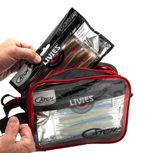 A hand grips a pack of fishing lures, ready to be stashed in the Catch Softbait Storage Bag—a must-have for keeping your softbaits and packaged lures perfectly organized!.